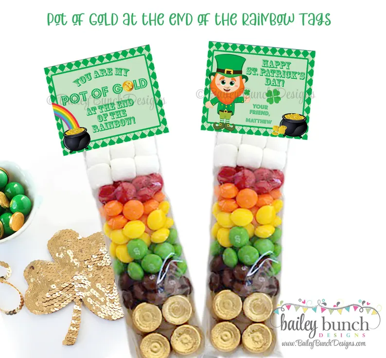 Colorful rainbow-themed cardstock toppers sealing clear bags filled with marshmallows, colorful candies, and gold chocolate coins as tiered St. Patrick's Day favors.