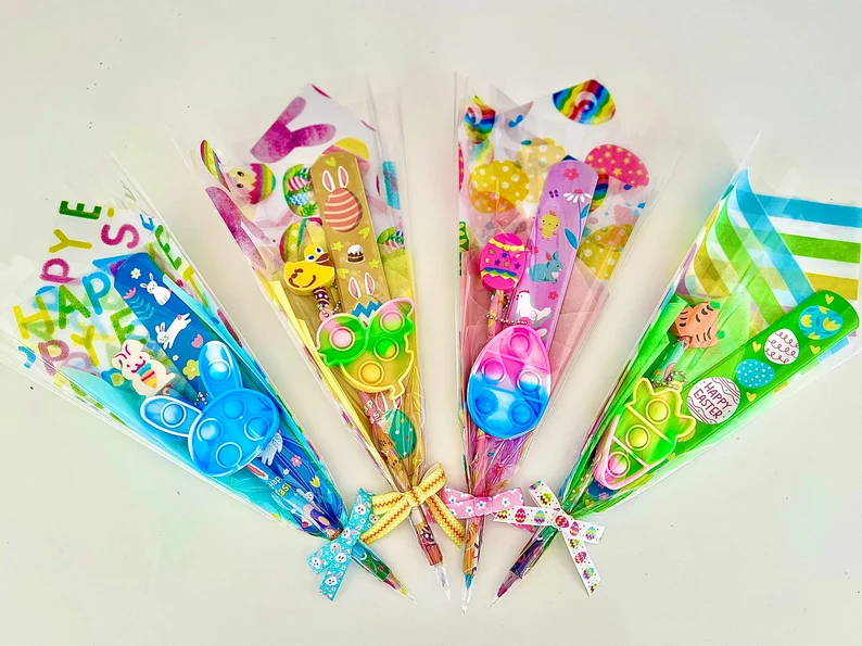 Cellophane-wrapped bouquet featuring a slap bracelet, fidget popper, and stickers, making a complete set of Easter Party Favors Kids.