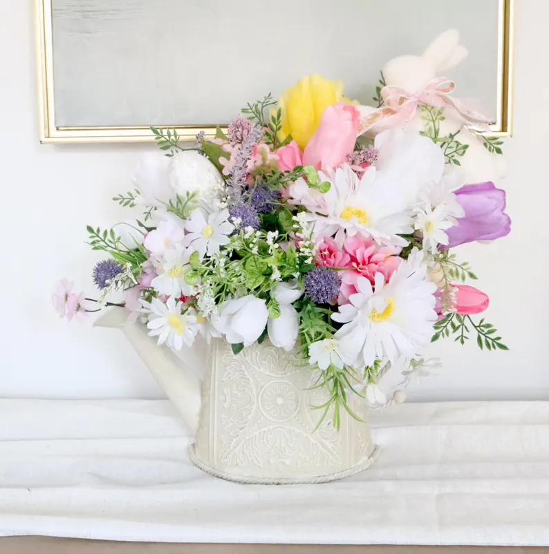 Vibrant spring bouquet in a white watering can with bunny accents, making a charming and festive Easter Hostess Gift.