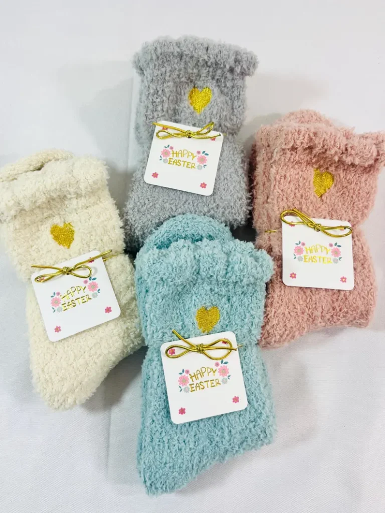 Colorful, fluffy socks with gold hearts and "Happy Easter" tags, perfect for cozy and practical additions to Adult Easter Baskets.