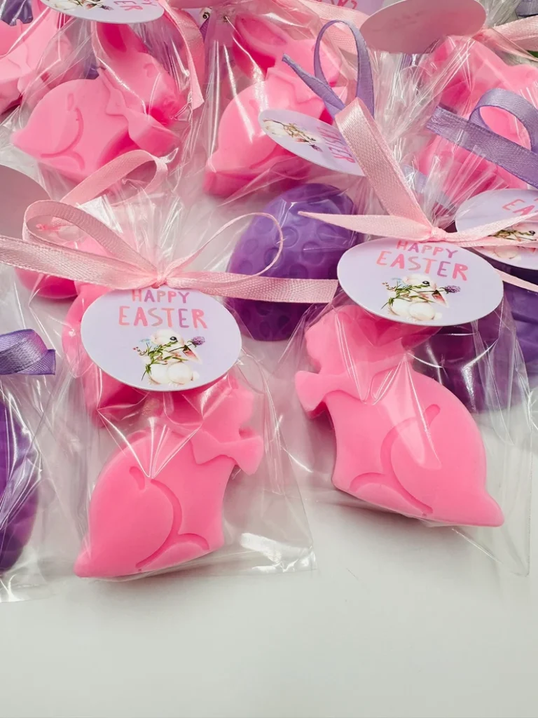 Adorable pink and purple bunny-shaped soaps in clear bags with "Happy Easter" tags, a clean and fun Easter Party Favors Kids option.