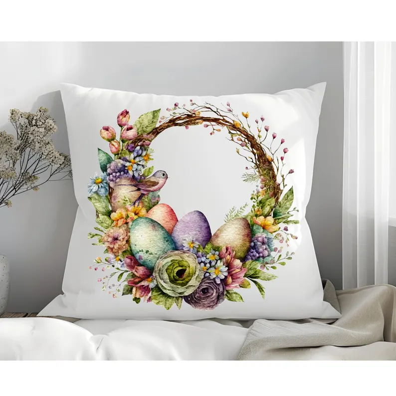 Watercolor floral wreath with pastel eggs and a bird on a white pillow, a charming Easter hostess gift.