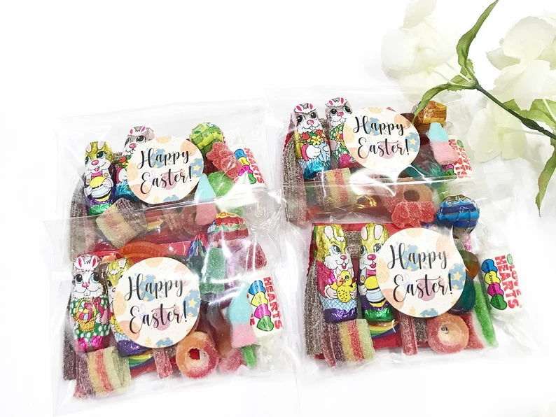 Clear bags filled with gummy candies and chocolate bunnies with "Happy Easter" stickers, classic Easter Party Favors Kids treats.