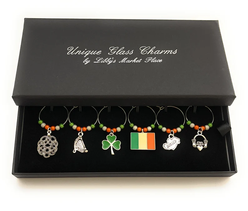 A boxed set of six Irish-themed wine glass charms, including harps and clovers, ideal St. Patrick's Day favors.
