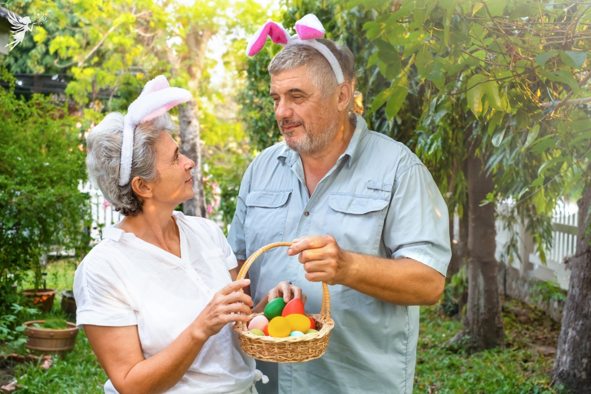 an elderly couple man and woman wearing bunny ears and sharing an easter basket