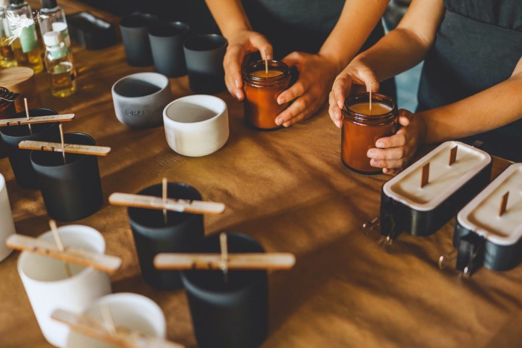 hands on a candle demonstrating a candle making workshop