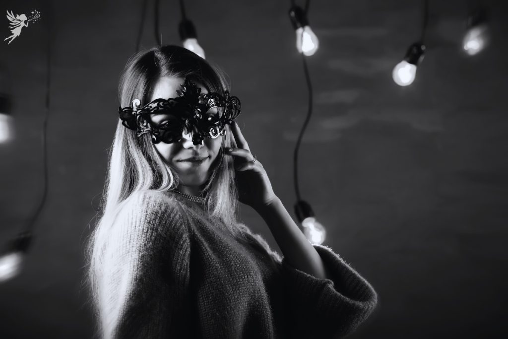 mysterious black and white women wearing a masquerade mask