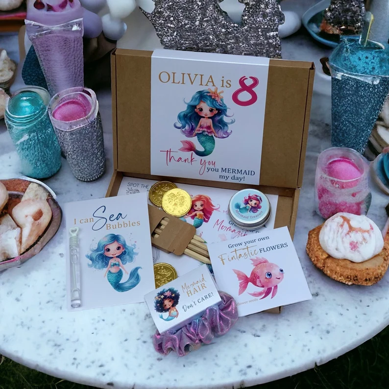Personalized prefilled mermaid party favor box containing bubbles, coins, hair ties, and activity cards offers complete ready-to-give mermaid party favors.