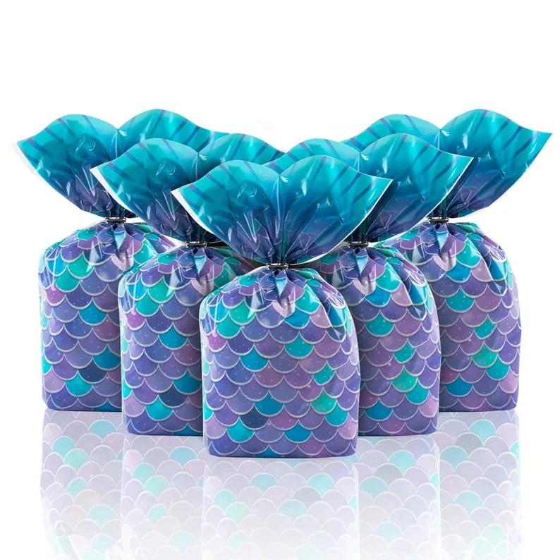 Iridescent mermaid tail shaped plastic goody bags with scale patterns provide eye-catching and convenient mermaid party favors for treat distribution.