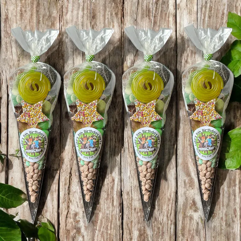 Minecraft-themed sweet cones filled with candies, star-shaped sprinkle cookies, and yellow licorice wheels with personalized birthday stickers, fun tween teen boy party favors.