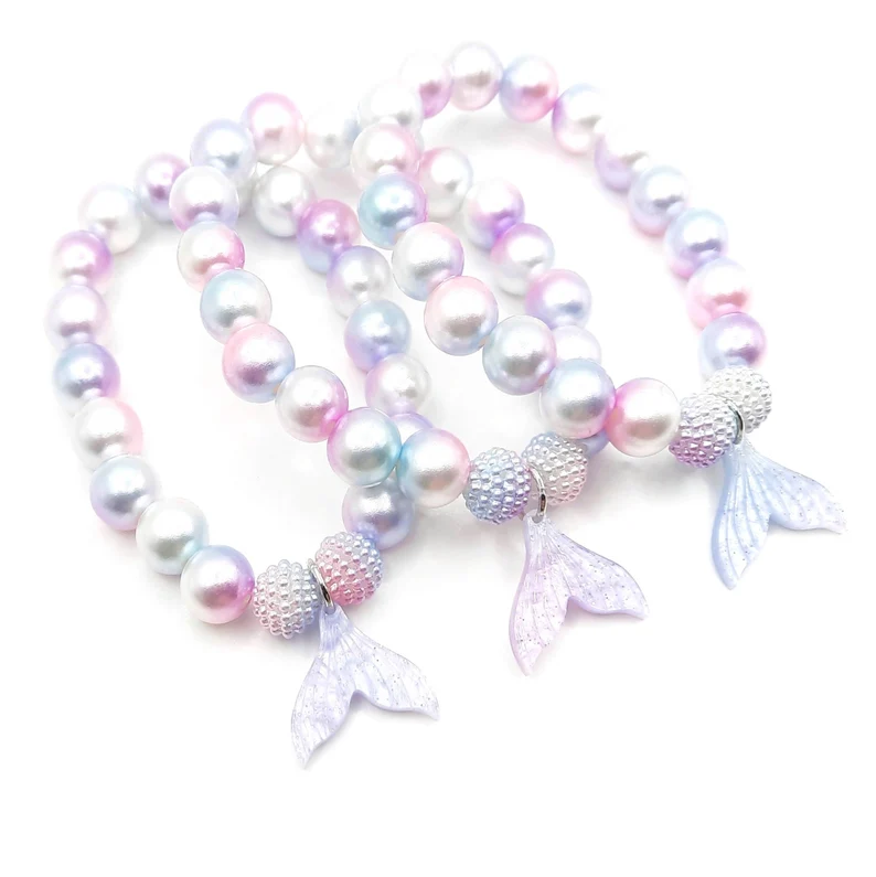 Pastel mermaid tail bracelets featuring iridescent pearl beads and translucent tail charms make delightful mermaid party favors for young guests.