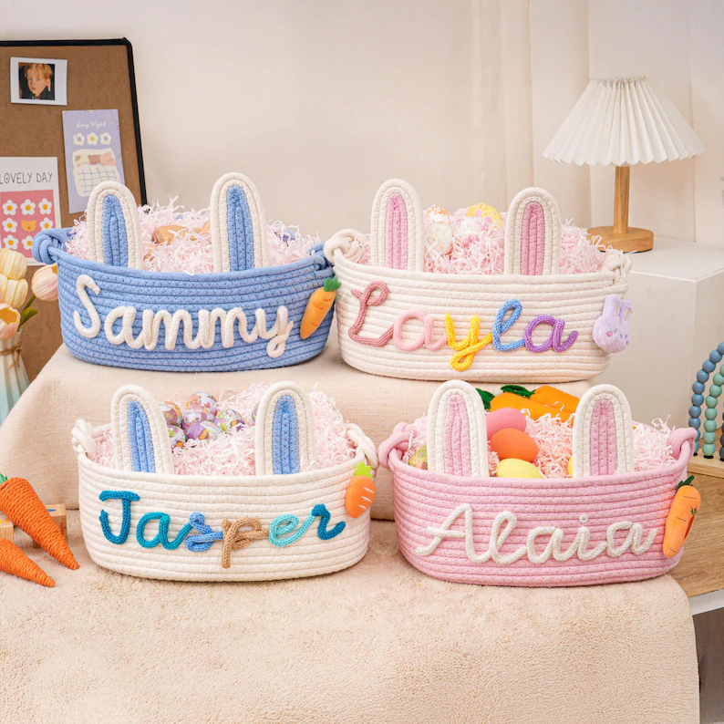 Personalized Easter baskets with embroidered names in colorful thread, featuring bunny ears and carrot accents, customizable baby Easter basket collection.