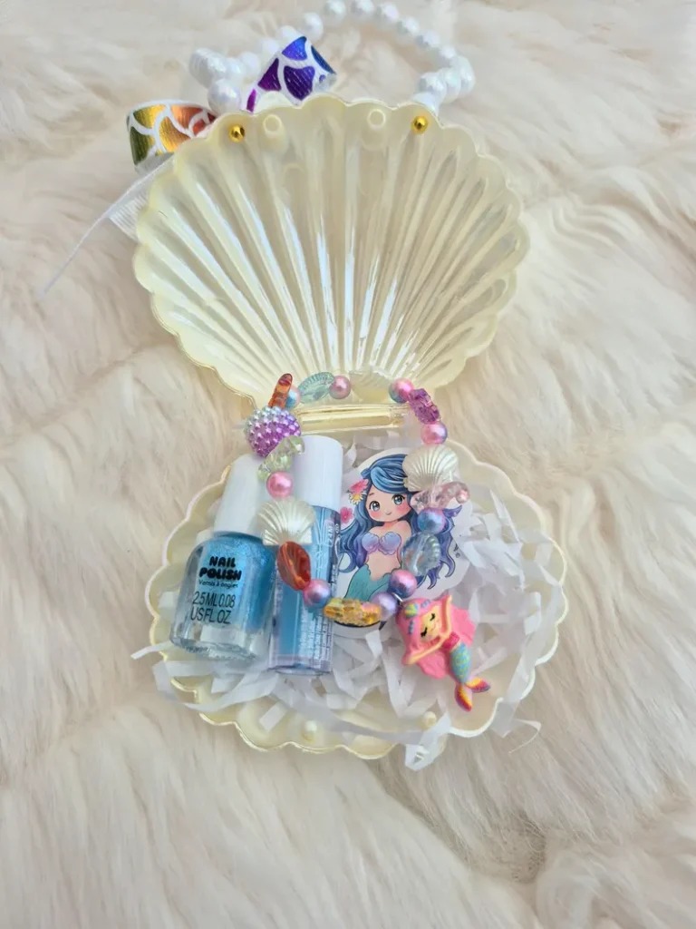 Pearlescent seashell bag prefilled with nail polish, lip gloss, hair clips, and mermaid toys makes charming all-in-one mermaid party favors.