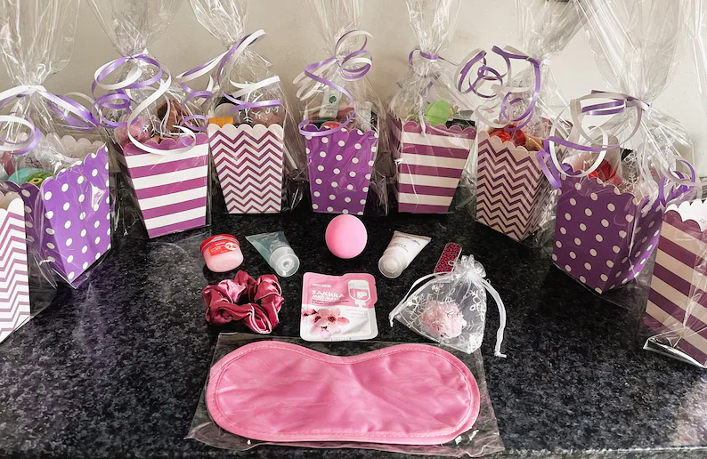 pretty pre-filled purple and white cups of party favors with pamper items