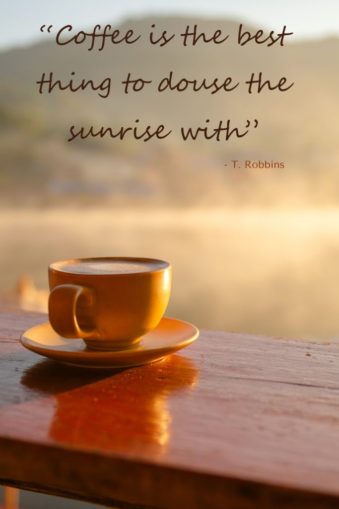 a yellow coffee cup on a tanle at sunrise text overlay Coffee is the best thing to douse the sunrise with