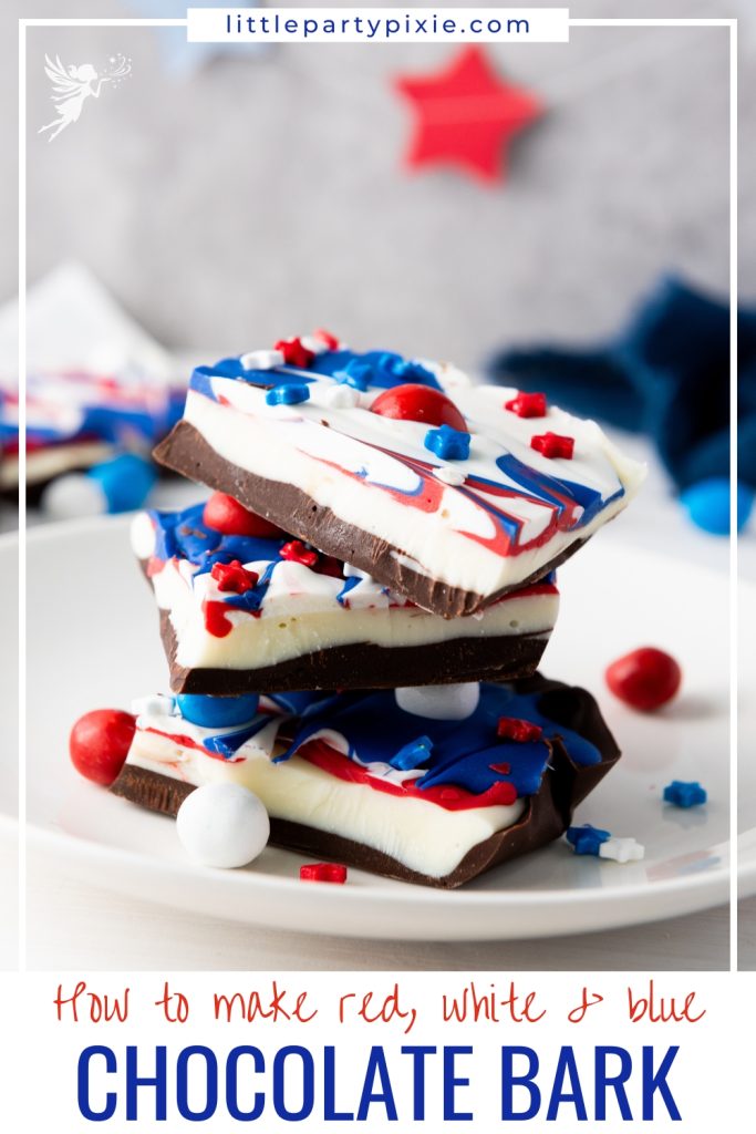 Stacked pieces of Red White & Blue Chocolate Bark with dark and white chocolate layers decorated with patriotic red and blue swirls and candies.