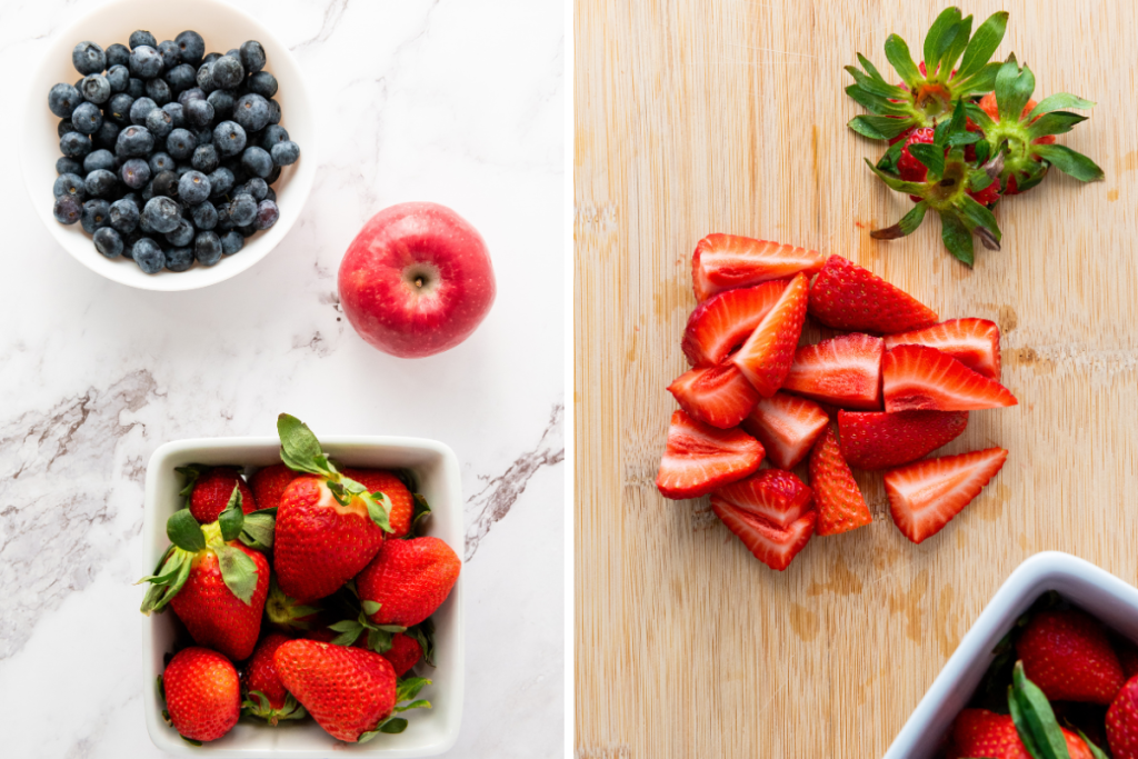 Ingredients for star spangled fruit salad including fresh blueberries, Pink Lady apple, and strawberries with quartered strawberries on cutting board.