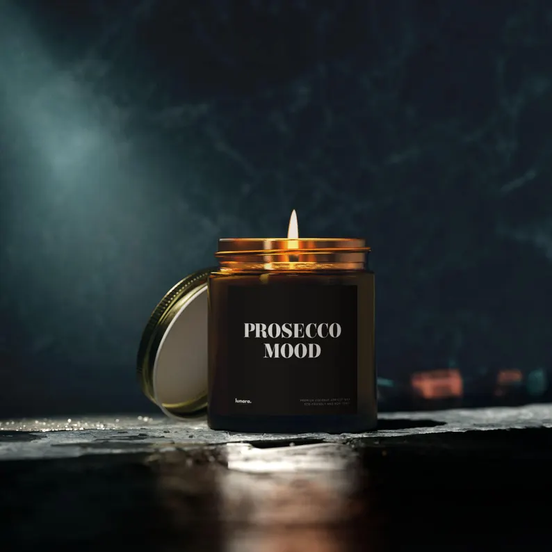 Dark amber "Prosecco Mood" candle with metallic gold rim glowing on textured surface—sophisticated prosecco gift ideas for sparkling wine lovers. Etsy