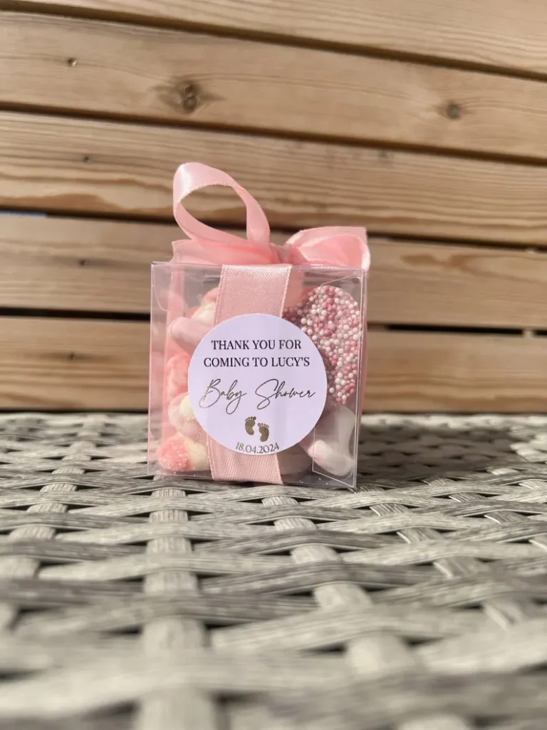 Chocolates cone bag box baby shower party favors featuring clear cube with pink candies, pearl sprinkles, satin ribbon, and personalized thank-you label. Etsy