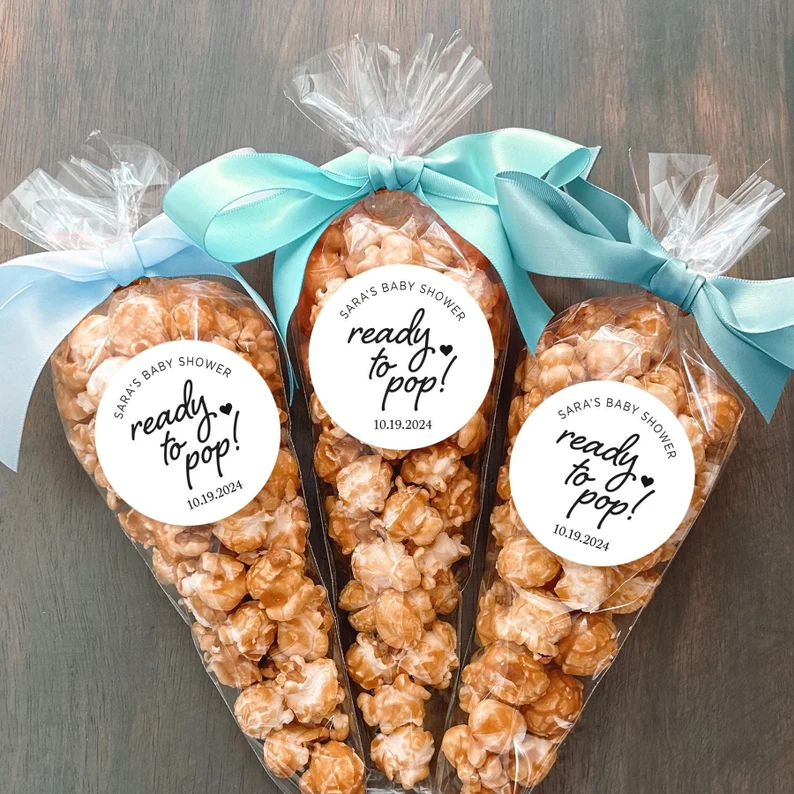 Popcorn favor labels bags baby shower party favors featuring caramel popcorn in clear cone bags with "ready to pop" stickers and blue ribbon bows. Etsy