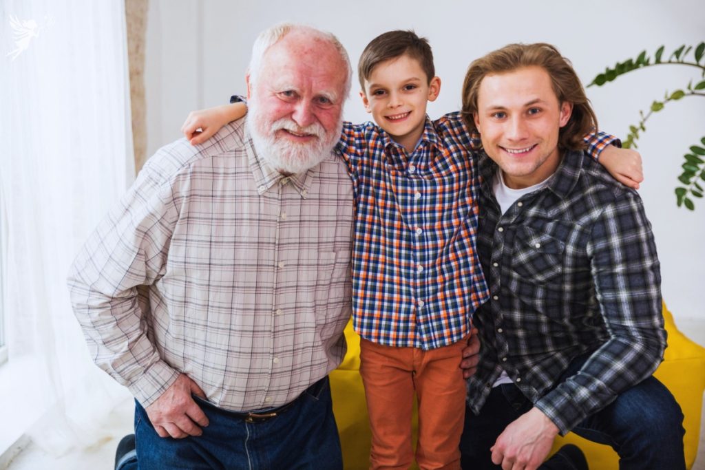 three generations of men cuddling for the camera photo shoot