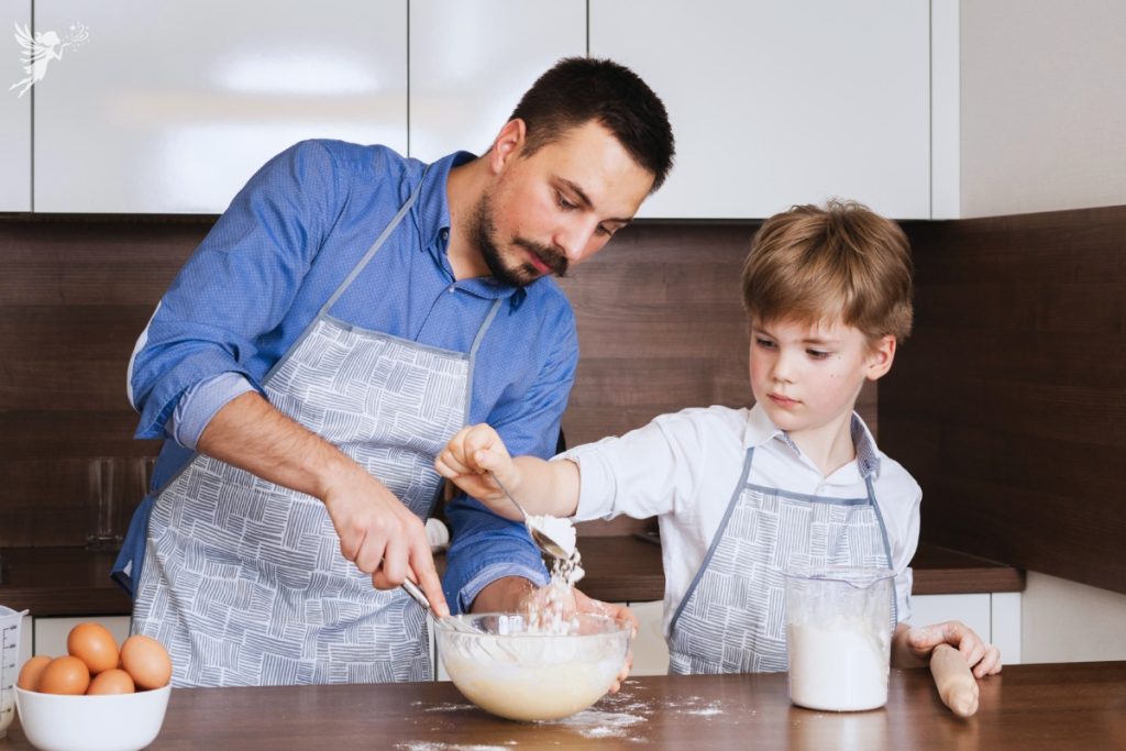 father and son in aprons doing baking