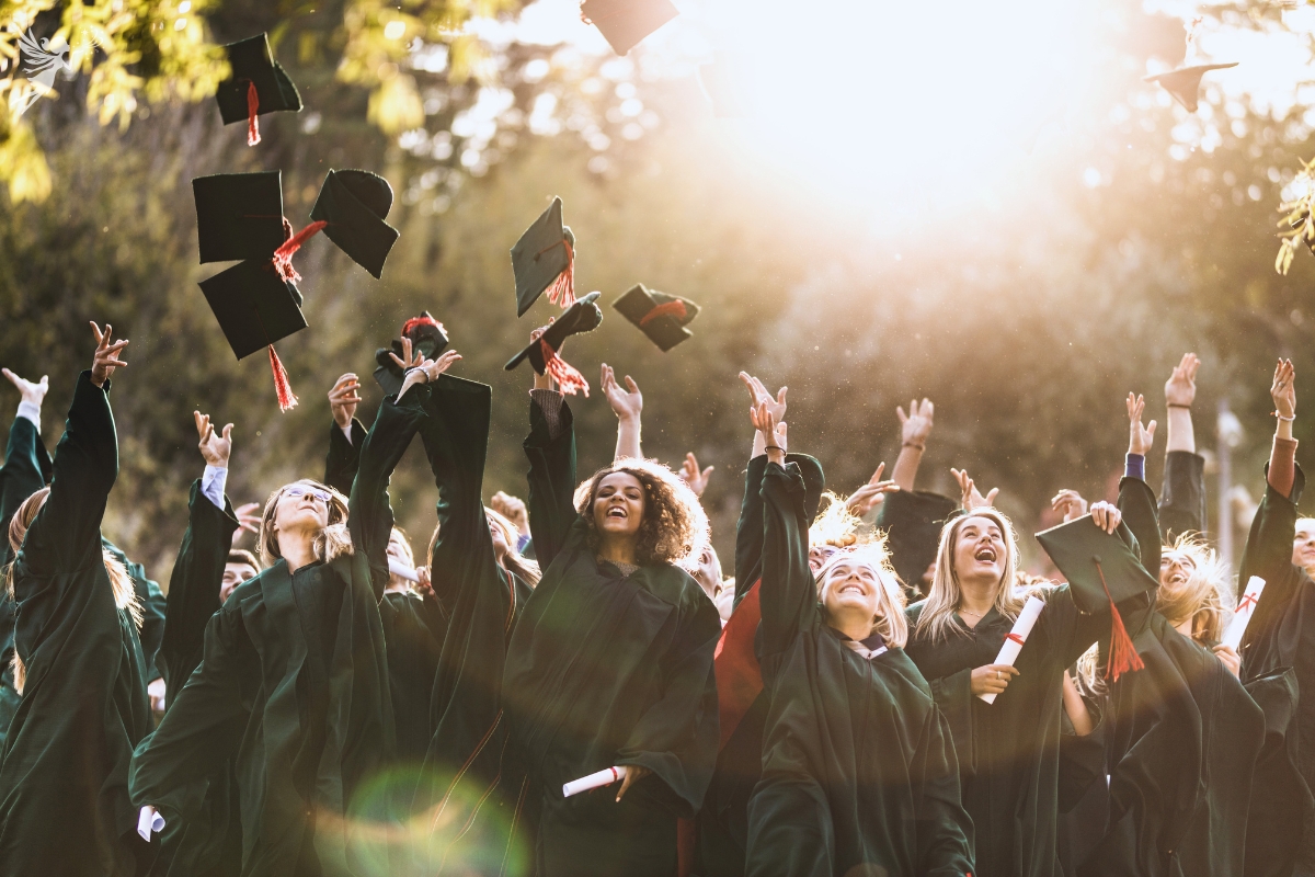 graduates throwing caps in the air