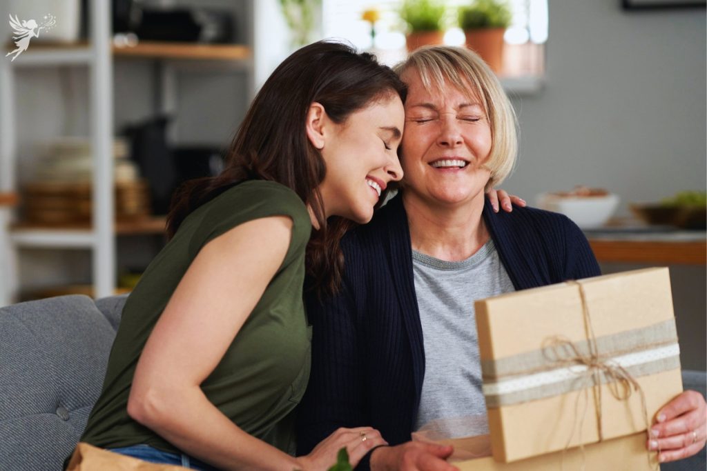 adult women cuddling her mp0ohter giving a surprise gift box
