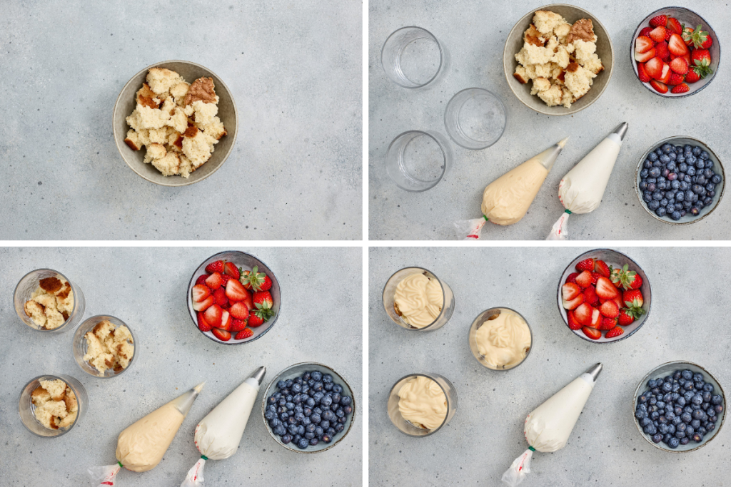 Overhead flat lay of sponge cake cubes, piping bags of pudding and whipped cream, strawberries, and blueberries ready to assemble red white and blue berry trifles.