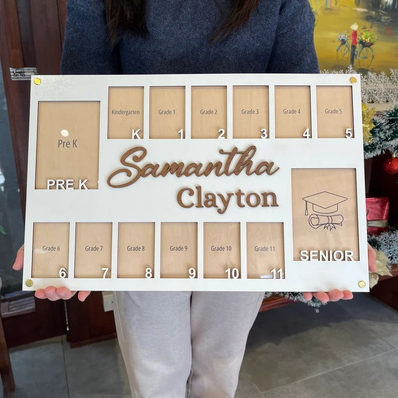 White wooden photo frame displaying slots from Pre-K through Senior year personalized with the name Samantha Clayton, a sentimental choice among graduation gifts. Etsy
