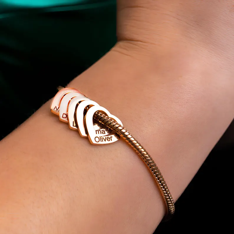 Rose gold personalized bracelet with heart shaped name charms on snake chain, elegant grandma gifts from grandkids with engraved names.