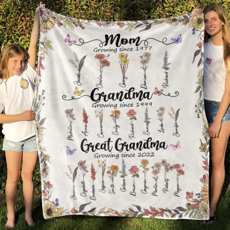 Personalized fleece blanket displaying mom to grandma progression with birth flowers and grandchildren names, warm grandma gifts from grandkids keepsake.