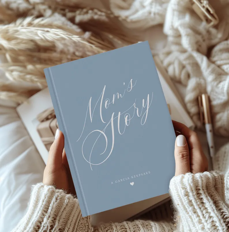 moms story blue cursive writing on hard bound journal