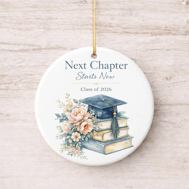 Round ceramic ornament printed with "Next Chapter Starts Now" and a watercolor graduation cap over stacked books with flowers, perfect as graduation gifts. Etsy