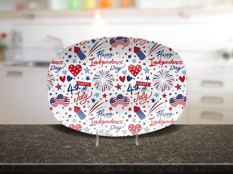 A patriotic serving tray printed with fireworks, stars, hearts, and 'Happy Independence Day' text — festive and practical 4th of July hostess gifts for summer entertaining. Etsy