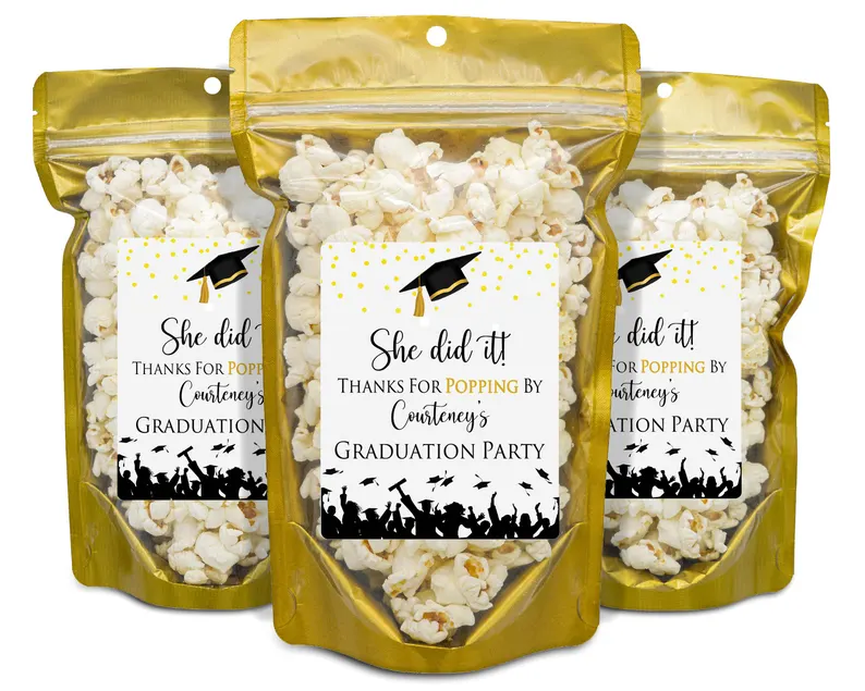 Three gold foil popcorn bags with personalized "She Did It" graduation party labels, making fun and affordable graduation gifts for party favors. Etsy