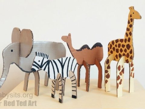 Cardboard safari animal toys including an elephant, zebra, camel, and giraffe for safari party crafts and activities