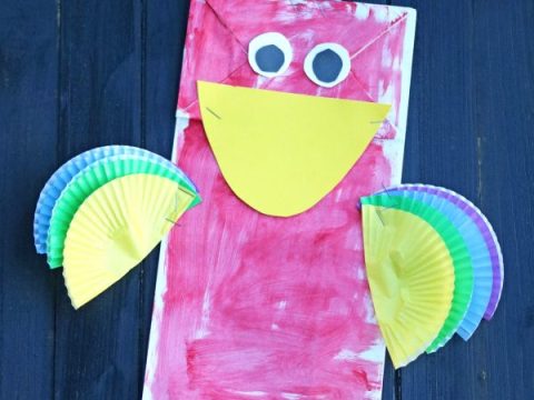 Colorful paper bag and cupcake liner parrot puppet craft for safari party crafts and activities
