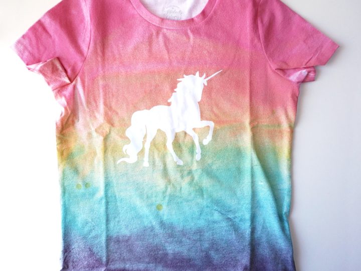 A DIY tie-dye rainbow unicorn shirt with a white unicorn silhouette is a wearable unicorn party craft and activity kids will treasure