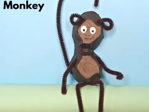 Egg carton monkey craft with pipe cleaner arms, legs, and tail for safari party crafts and activities