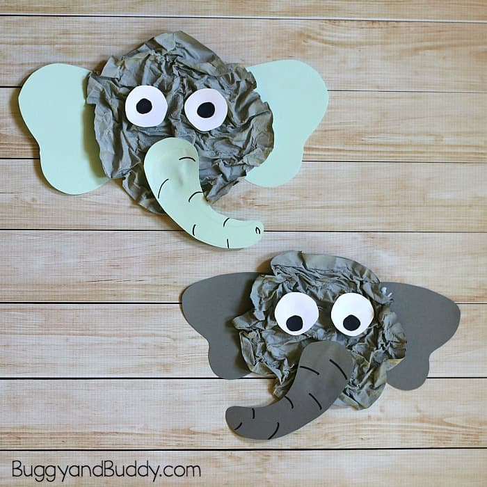 Two crumpled newspaper elephant face crafts with paper ears and googly eyes for safari party crafts and activities