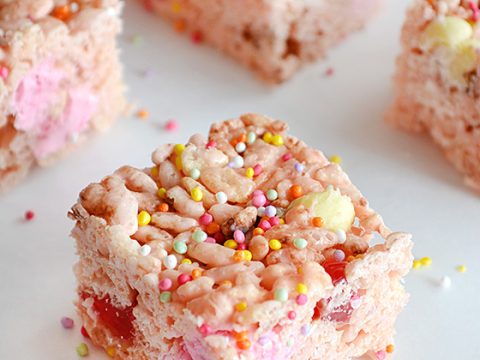 Pink rice crispy fairy fudge squares topped with rainbow sprinkles and marshmallows — a fun kids-can-cook fairy party food treat full of whimsy.
