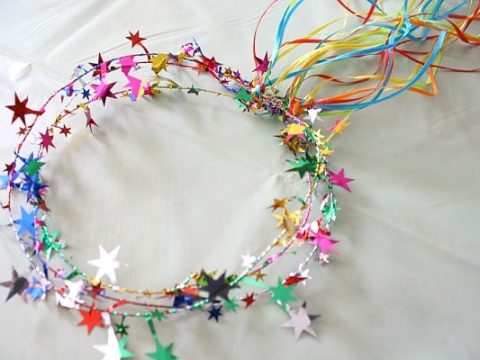 A sparkly multicolored star tiara with colorful ribbon streamers, a festive and fun fairy party crafts and activities crown kids can make.