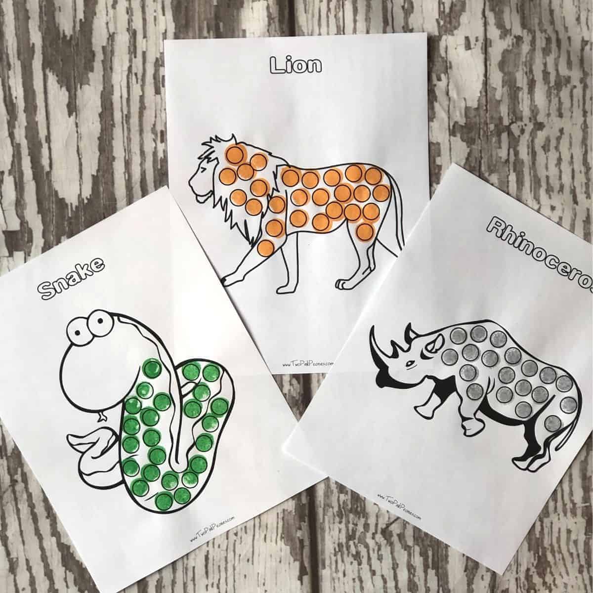 Free printable safari animals dot marker pages featuring a lion, snake, and rhino for safari party crafts and activities