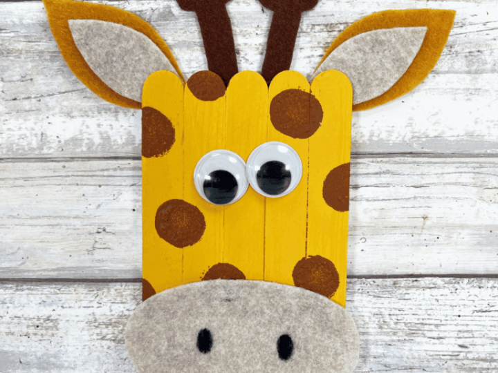 Adorable popsicle stick giraffe with googly eyes and felt ears for safari party crafts and activities