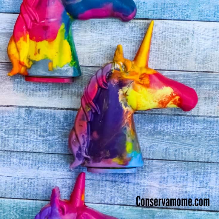Colorful melted crayon unicorn head shapes in swirled rainbow colors are unique and creative unicorn party crafts and activities