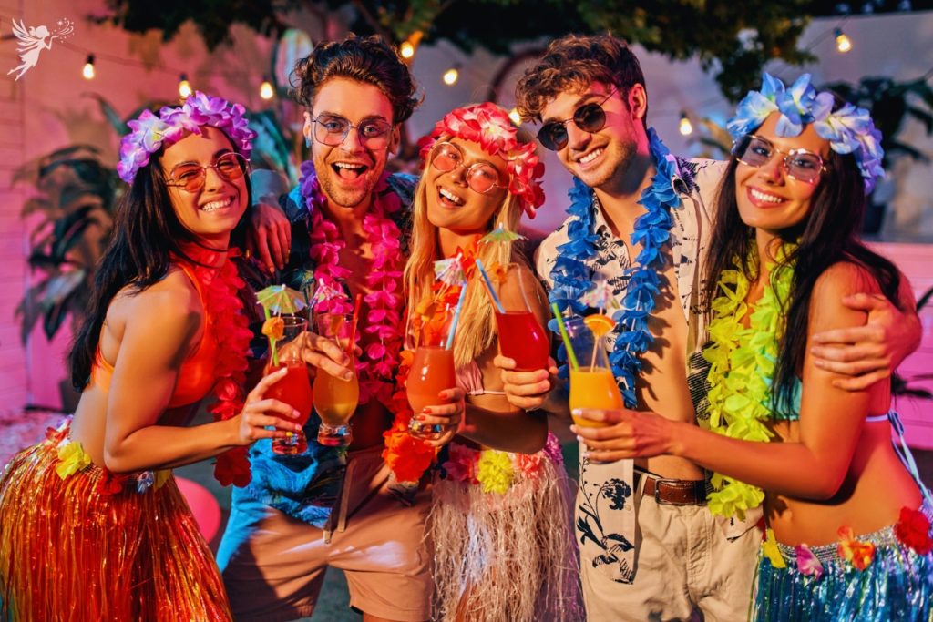 group of friends in leis and hawaiian clothing at luau