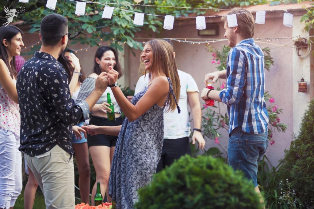 adults having a backyard bbq party daytime
