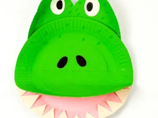 Bright green paper plate crocodile craft with teeth and googly eyes for safari party crafts and activities