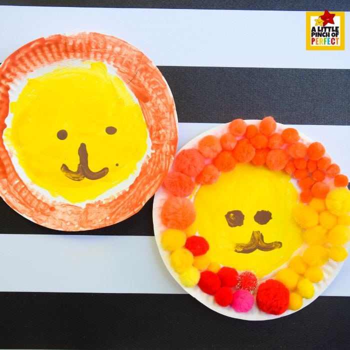 Paper plate lion crafts with painted faces and colorful pom pom manes for safari party crafts and activities